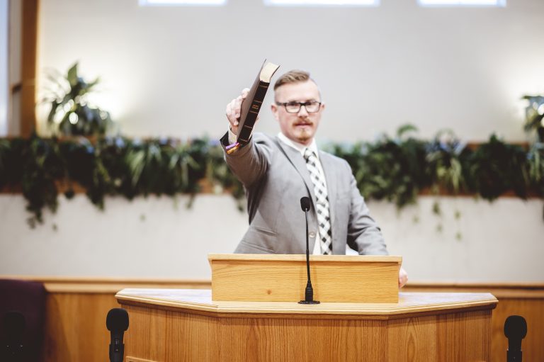 גבר מחזיק ספר על במה